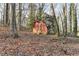 Rustic red shed nestled in a wooded backyard at 1695 Bull Sw Run, Lilburn, GA 30047