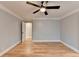 Light-filled bedroom with hardwood floors and access to hallway at 1695 Bull Sw Run, Lilburn, GA 30047