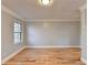 Well-lit bedroom featuring hardwood floors and a window at 1695 Bull Sw Run, Lilburn, GA 30047