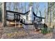 Charming white house with black accents, deck, and stone chimney at 1695 Bull Sw Run, Lilburn, GA 30047