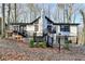 Charming white house with black accents, deck, and stone chimney at 1695 Bull Sw Run, Lilburn, GA 30047