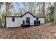White house with black deck and wooded area at 1695 Bull Sw Run, Lilburn, GA 30047