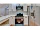 Newly renovated kitchen featuring teal appliances and white cabinets at 1695 Bull Sw Run, Lilburn, GA 30047