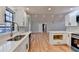 Open concept kitchen with island, white cabinets and hardwood floors at 1695 Bull Sw Run, Lilburn, GA 30047