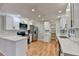 Updated kitchen with white cabinets, quartz countertops, and stainless steel appliances at 1695 Bull Sw Run, Lilburn, GA 30047