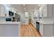 Modern kitchen boasts white cabinets, quartz countertops, and stainless steel appliances at 1695 Bull Sw Run, Lilburn, GA 30047