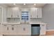 White kitchen with stainless steel appliances and double sink at 1695 Bull Sw Run, Lilburn, GA 30047