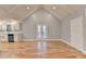 Open concept living room and kitchen with hardwood floors and vaulted ceilings at 1695 Bull Sw Run, Lilburn, GA 30047