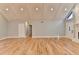Spacious living room with hardwood floors, vaulted ceiling, and white beams at 1695 Bull Sw Run, Lilburn, GA 30047