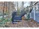 Black railings wooden stairs leading to deck at 1695 Bull Sw Run, Lilburn, GA 30047