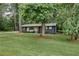 House nestled amongst mature trees on a spacious lot at 131 Brookwood Sw Dr, Marietta, GA 30064