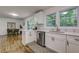 White kitchen with stainless steel appliances and view of dining area at 131 Brookwood Sw Dr, Marietta, GA 30064