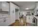 Modern kitchen with white cabinets, stainless steel appliances, and hardwood floors at 131 Brookwood Sw Dr, Marietta, GA 30064