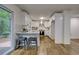 Modern white kitchen with stainless steel appliances and a breakfast bar at 131 Brookwood Sw Dr, Marietta, GA 30064