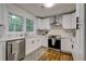 Updated kitchen with white shaker cabinets, quartz countertops, and geometric backsplash at 131 Brookwood Sw Dr, Marietta, GA 30064