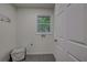 Bright laundry room with tile floor and window at 131 Brookwood Sw Dr, Marietta, GA 30064