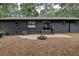 Brick patio with fire pit in a wooded backyard setting at 131 Brookwood Sw Dr, Marietta, GA 30064