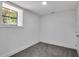 Bright basement bedroom with grey carpet, large window, and neutral walls at 3483 Winter Chase Dr, Marietta, GA 30062