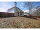 View of the house from the backyard, showcasing a large yard and wooden fence at 1444 Tether Ln, Mcdonough, GA 30253