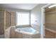 Bathroom boasts corner soaking tub and walk-in shower at 1444 Tether Ln, Mcdonough, GA 30253