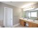 Double vanity bathroom with a large mirror and window at 1444 Tether Ln, Mcdonough, GA 30253