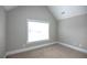 Bright bedroom with carpeting and large window at 1444 Tether Ln, Mcdonough, GA 30253