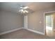 Spacious bedroom with ceiling fan and access to hall at 1444 Tether Ln, Mcdonough, GA 30253