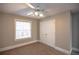 Bedroom with window, ceiling fan and double doors at 1444 Tether Ln, Mcdonough, GA 30253