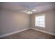 Bedroom with window, ceiling fan and neutral decor at 1444 Tether Ln, Mcdonough, GA 30253