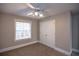 Bedroom with window, ceiling fan and double doors at 1444 Tether Ln, Mcdonough, GA 30253