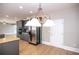 Kitchen dining area with hardwood floors and a chandelier at 1444 Tether Ln, Mcdonough, GA 30253