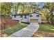 Newly renovated home with a driveway and manicured lawn at 2873 Bob Bettis Rd, Marietta, GA 30066