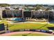 Full view of Coolray Field, apartments, and a vast grassy field with commercial advertisement on the fencing at 6945 Melody Dr, Buford, GA 30518