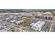 Expansive aerial view displaying the mixed-use development with apartments, retail areas, and recreational facilities at 6945 Melody Dr, Buford, GA 30518