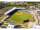 Aerial view of the baseball stadium with a well-manicured field surrounded by seating and nearby apartments at 6945 Melody Dr, Buford, GA 30518