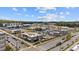 Wide aerial shot of a lively community featuring retail spaces, apartments, and beautifully landscaped surroundings at 6945 Melody Dr, Buford, GA 30518