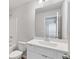 Bright bathroom with white cabinets, sink and large mirror at 6945 Melody Dr, Buford, GA 30518