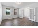 Bedroom featuring two windows, wood floors, and an adjoining room at 6945 Melody Dr, Buford, GA 30518