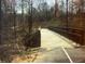 View of a concrete walking bridge surrounded by trees at 6945 Melody Dr, Buford, GA 30518