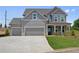 Beautiful two-story home featuring a three-car garage and a well-manicured lawn at 6945 Melody Dr, Buford, GA 30518