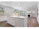 A kitchen island overlooking the living room with a fireplace at 6945 Melody Dr, Buford, GA 30518