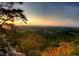 Scenic view of a valley and sunset from an overlook with trees and rock formations at 6945 Melody Dr, Buford, GA 30518