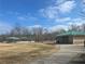 Green-roofed building and open field enhance the park, providing recreational space and scenic views of nature at 6945 Melody Dr, Buford, GA 30518