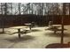 Picnic tables are situated in a park setting, offering a pleasant place for outdoor dining and socializing at 6945 Melody Dr, Buford, GA 30518