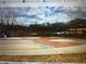 Play area with a colorful surface and benches near the surrounding parking and pavilion at 6945 Melody Dr, Buford, GA 30518