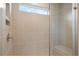 This is a stylish tiled shower with glass door and a small window allowing for natural light at 6945 Melody Dr, Buford, GA 30518