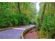 Scenic walking trail with wooden pathway through lush green foliage at 6945 Melody Dr, Buford, GA 30518