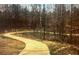 A winding walking trail surrounded by trees and natural landscape at 6945 Melody Dr, Buford, GA 30518