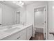 Bathroom with double vanity, white cabinets and a shower at 6949 Melody Dr, Buford, GA 30518