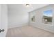 Well-lit bedroom featuring neutral walls and carpet at 6949 Melody Dr, Buford, GA 30518